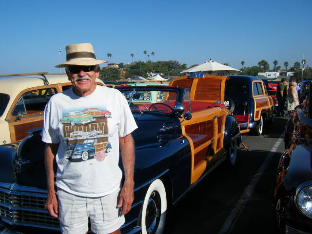 Russ Neher in front of his Newport Blue T&C  convertible